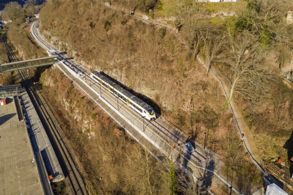 A train travels along a route near the forest, crosses a bridge, test run on the new Hermann-Hesse railway with Siemens Mireo Plus B trains, Calw, Germany