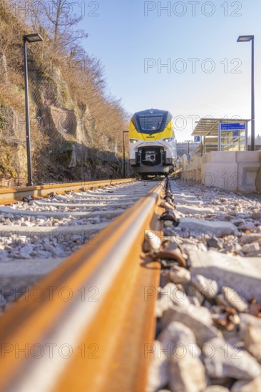 Close-up of a modern train on gravel tracks in sunlight, test run on the new Hermann-Hesse railway with Siemens Mireo Plus B trains, Calw, Germany