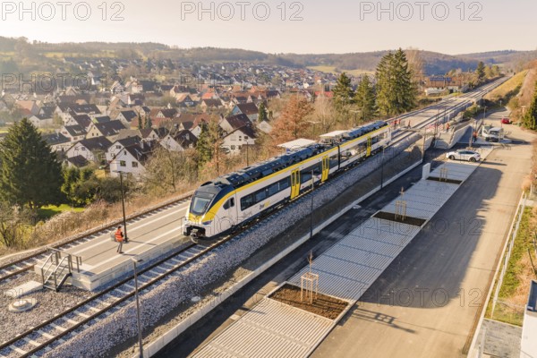 Train at a train station in a rural area surrounded by hills and houses, test ride on the new Hermann-Hesse railway with Siemens Mireo Plus B trains, Calw, Germany