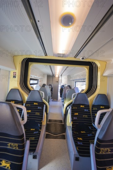 Modern train interior with yellow-blue seats and bright lighting, test run on the new Hermann-Hesse railway with Siemens Mireo Plus B trains, Calw, Germany