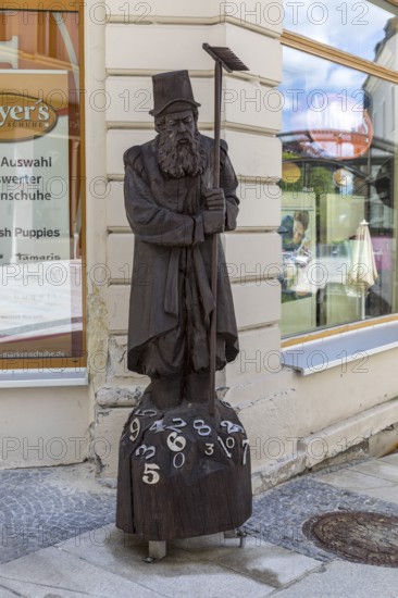 Wooden sculpture of Adam Ries as an arithmetic with numbers, signpost to the Adam Ries House and memorial in Annaberg, Annaberg-Buchholz, Erzgebirge, Saxony, Germany