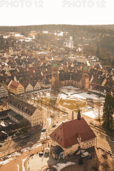 Historic city view with church and snow-covered roofs under bright blue sky, Freudenstadt, Black Forest, Germany