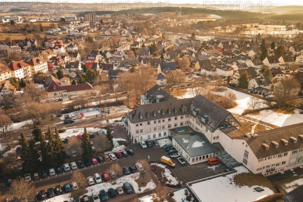 A part of a city with buildings, open parking areas and snow to see, District Office, Freudenstadt, Black Forest, Germany
