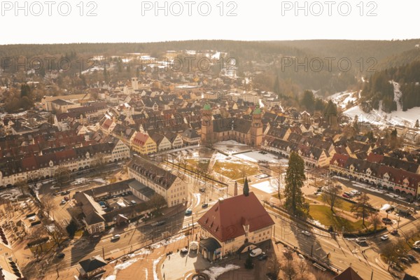 Panoramic view of an old town with distinctive church and snow-covered roofs in winter light, Freudenstadt, Black Forest, Germany