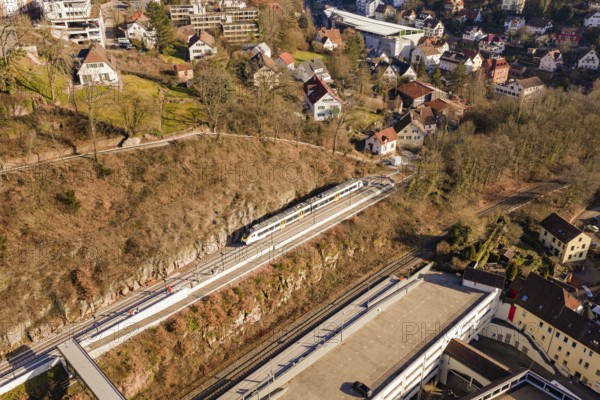 Houses and urban structure on hilly landscape with train on tracks, test run on the new Hermann-Hesse railway with Siemens Mireo Plus B trains, Calw, Germany