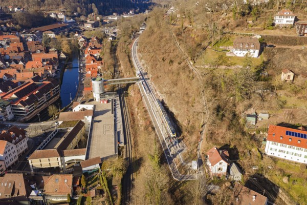 City panorama with train lines along a hill that run through an urban environment, test run on the new Hermann-Hesse railway with Siemens Mireo Plus B trains, Calw, Germany