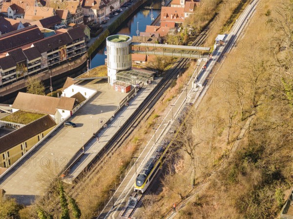 Train line with bridge near city center, embedded in fascinating architecture, test run on the new Hermann-Hesse railway with Siemens Mireo Plus B trains, Calw, Germany