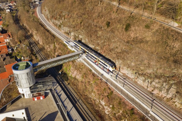 Train ride across bridge in hilly landscape surrounded by vegetation and town houses, test trip on the new Hermann Hesse railway with Siemens Mireo Plus B trains, Calw, Germany