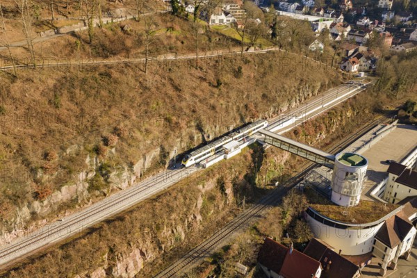 Aerial view of a railway station in an urban area, surrounded by nature and architecture, test run on the new Hermann-Hesse railway with Siemens Mireo Plus B trains, Calw, Germany