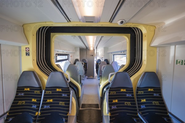 Train compartment with yellow accents and grey seats in bright surroundings, test run on the new Hermann-Hesse railway with Siemens Mireo Plus B trains, Calw, Germany
