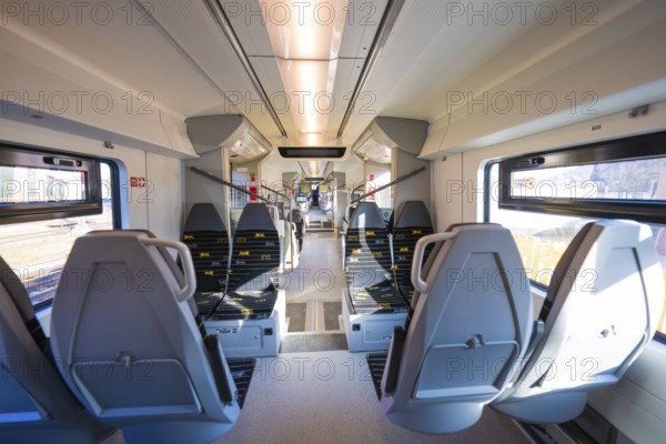 Modern train interior with grey seats and bright daylight through the windows, test run on the new Hermann-Hesse railway with Siemens Mireo Plus B trains, Calw, Germany