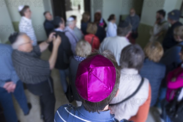Visitors wear a kippah while visiting a synagogue, Ukraine