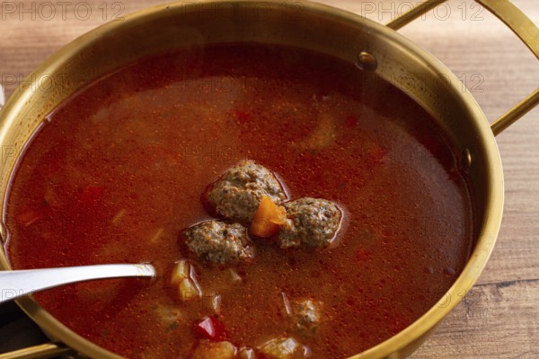 Romanian soup with meatballs, vegetable soup with meatballs, in a pot, homemade, no people