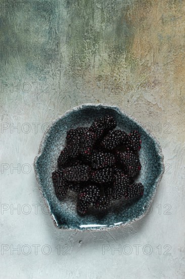 Fresh blackberry berry, on a plate, top view, no people