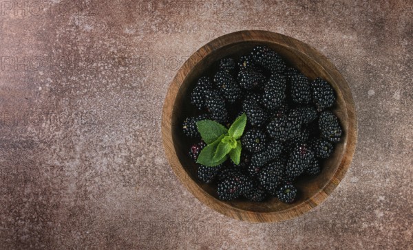 Blackberries, in a wooden bowl, top view, no people
