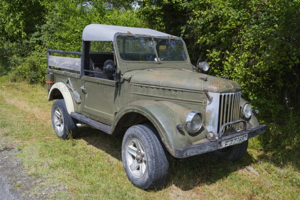 Old green off-road vehicle in rural area with trees and grasses, 4WD vehicle, GAZ-69, Georgia