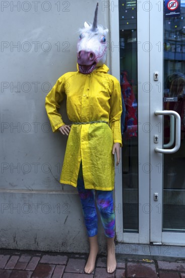 Mannequin with rain cape and unicorn mask, Krakow, Poland