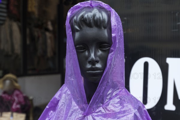 Window mannequin with rain cape in rain, Krakow, Poland