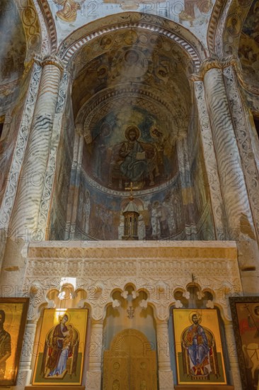 Richly decorated Orthodox church wall with frescoes and icons in the interior, Nikorzminda Cathedral, Racha-Lechkhumi region, Lower Svaneti, Georgia