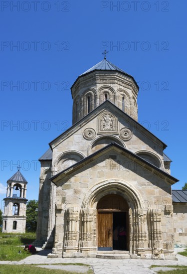 Historic stone church with bell tower against a clear sky, Nikorzminda Cathedral, Nikorzminda Cathedral, Racha-Lechkhumi region, Lower Svaneti, Georgia