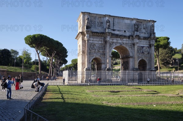 Arch of Constantine with tourists on sunny day, Lazio, Italy
