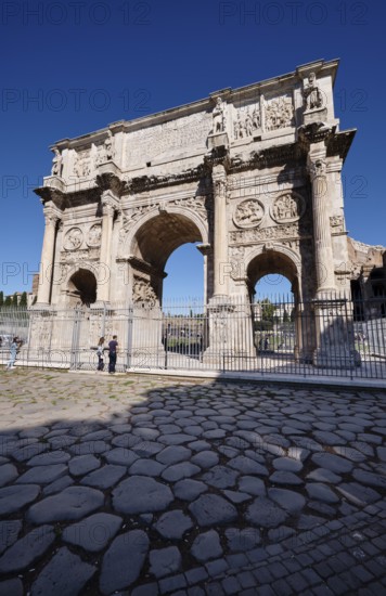Arch of Constantine with detailed reliefs under blue sky, Rome, Lazio, Italy
