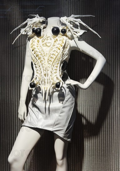 Spider-dress, eccentric, spider-like ecoskeleton as a white dress with AI and defense technology for woman with biofeedback, smart clothing, exhibition, history of the future, Germany