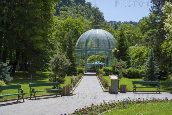 A path through a green park leads to a pavilion surrounded by flowers and trees, pavilion with mineral water spring, Borjomi, Borjomi, Borjomi resort, Borjomi, Samtskhe-Javakheti region, Samtskhe-Javakheti, Lesser Caucasus, Georgia