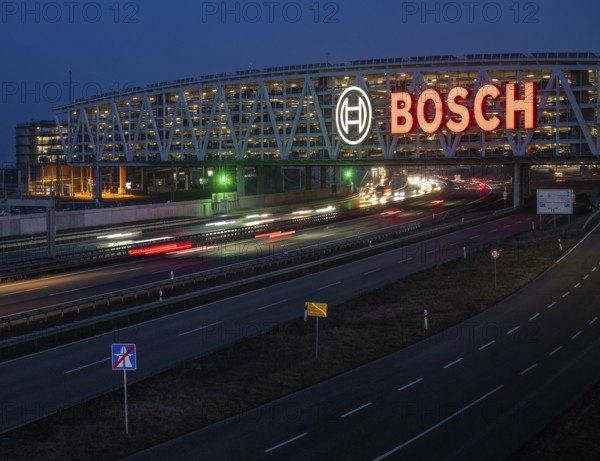 Traffic on the A8 motorway, blue hour, illuminated parking garage, Landesmesse Stuttgart, red-lit Bosch logo, second-largest logo in the world 55 meters wide, Baden-Württemberg, Germany