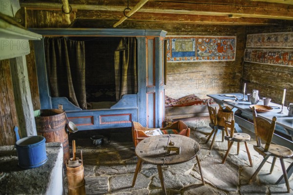 Rustic dining room with wooden table and chairs, wall paintings and antique charm in the birthplace of botanist and founder of the binary nomenclature Carl von Linné, Linnés Råshult, Älmhult, Kronobergs län, Småland, Sweden