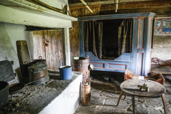 Rustic old kitchen with antique stove and blue-painted wooden furniture. The soil is made of stone in the birthplace of botanist and founder of the binary nomenclature Carl von Linné, Linnés Råshult, Älmhult, Kronobergs län, Småland, Sweden