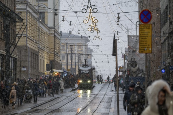 Alexanterinkatu, main shopping street in the city center, designed by Carl Ludwig Engel, Christmas decoration, tram tracks, snowfall, Helsinki, Finland