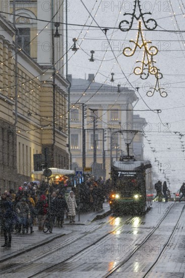 Alexanterinkatu, main shopping street in the city center, designed by Carl Ludwig Engel, Christmas decoration, tram tracks, snowfall, Helsinki, Finland