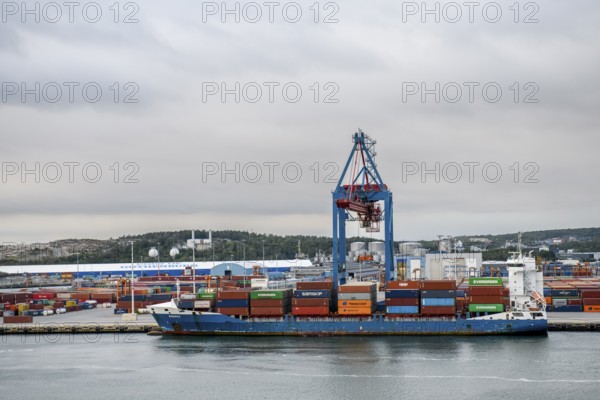Container ship in port surrounded by several cranes Container bridges, Gothenburg, Västra Götalands län, Sweden and containers