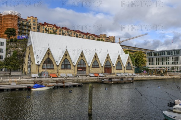 Large historic market hall in Gothenburg with pointed roof on the water, Gothenburg, Västra Götalands län, Sweden