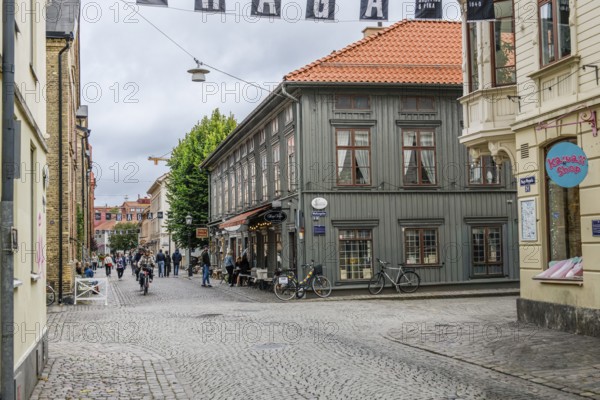 Charming old town with cobblestones and historic buildings, people walking on the street in Gothenburg's Haga district, Gothenburg, Västra Götalands län, Sweden