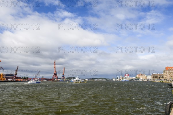 City and harbor landscape with cranes and cloudy sky, Gothenburg, Västra Götalands län, Sweden