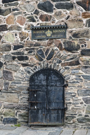 Iron door in old stone wall with Skansen Kronan sign, Gothenburg, Västra Götalands län, Sweden