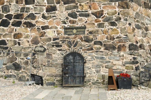 Detail of an old stone wall stone tower in Gothenburg's Skansen Kronan fortress with historical signs, rustic masonry, Gothenburg, Västra Götalands län, Sweden