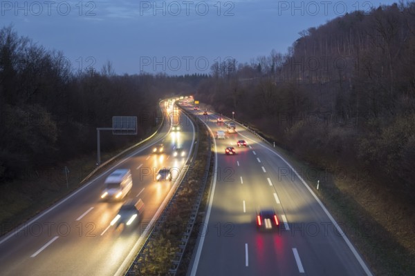 Night view of a motorway trip in the dark, surrounded by forest and vehicle lights, near Stuttgart, Baden-Württemberg, Germany