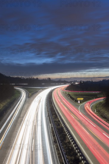 Long-exposure highway at night with light trails and cloudy sky over the countryside, near Stuttgart, Baden-Württemberg, Germany