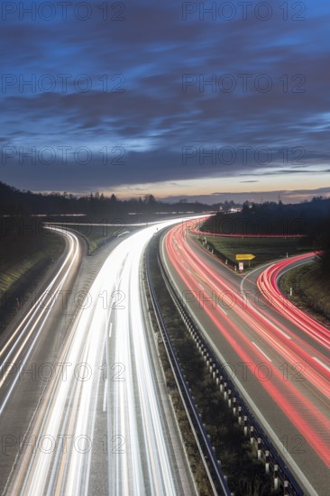 Long-exposure view of a motorway at night with continuous light trails on a blue sky, near Stuttgart, Baden-Württemberg, Germany