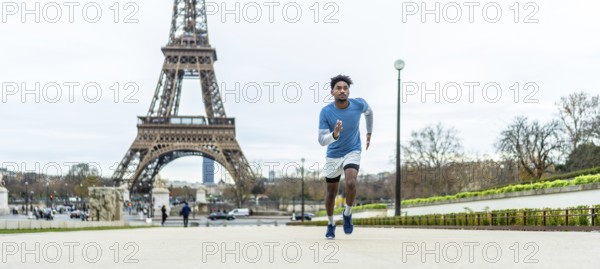 Young athletic man jogging through paris streets, focused on training and enjoying an outdoor workout with the blurred eiffel tower and cityscape in the background