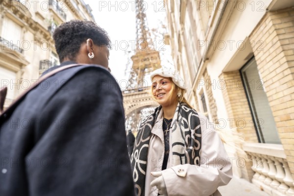 Happy couple happily conversing on a picturesque paris street with the iconic eiffel tower in the background, embodying travel, romance, and an urban adventure