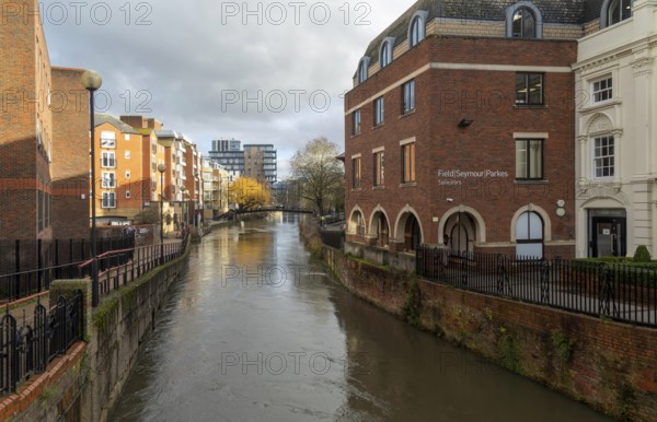 River Kennet flowing past apartment housing and businesses, view east from London Street, Reading, Berkshire, England, UK