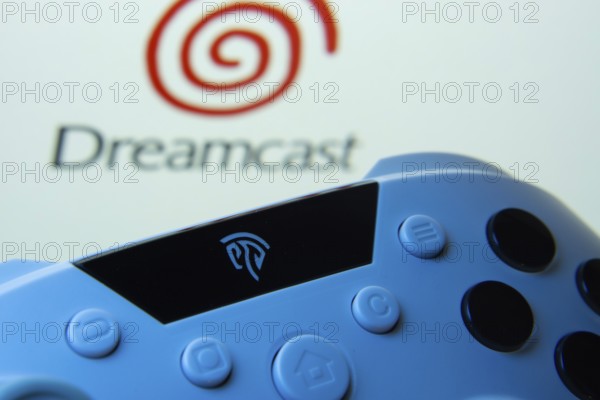 Dhaka, Bangladesh- 24 Mar 2025: A close-up of a gamepad with the Dreamcast seen on screen in the background
