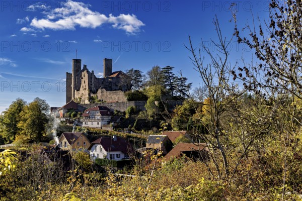 Autumn view of the village with castle on a hill under a clear sky, Hanstein Castle near Bornhagen in the Eichsfeld district of Thuringia