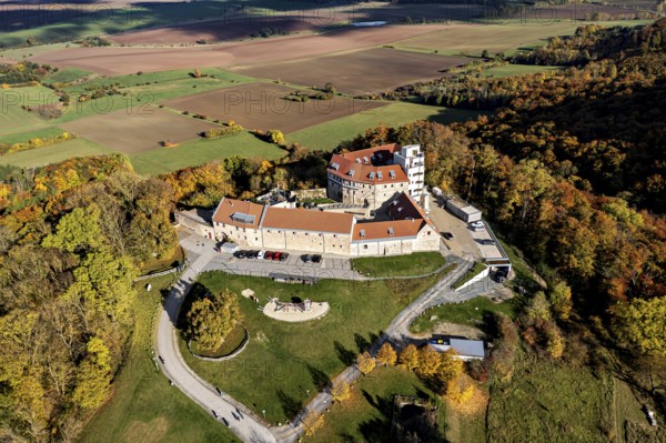 A castle on a hill with a bird's eye view of autumnal forests and fields, Schharfenstein Castle in the Eichsfeld district of Thuringia