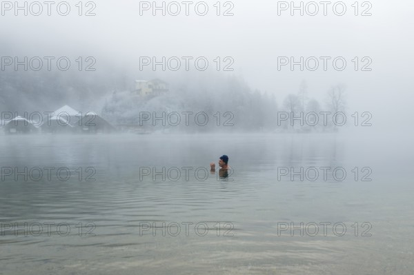 Man with cap, 55, ice bathing, including winter bathing in Königssee, Schönau am Königssee, Berchtesgadener Land, Upper Bavaria, Bavaria, Germany