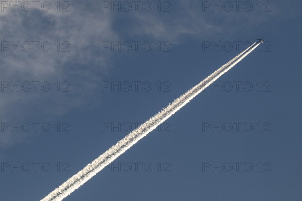 Contrails and passenger jets high in the sky